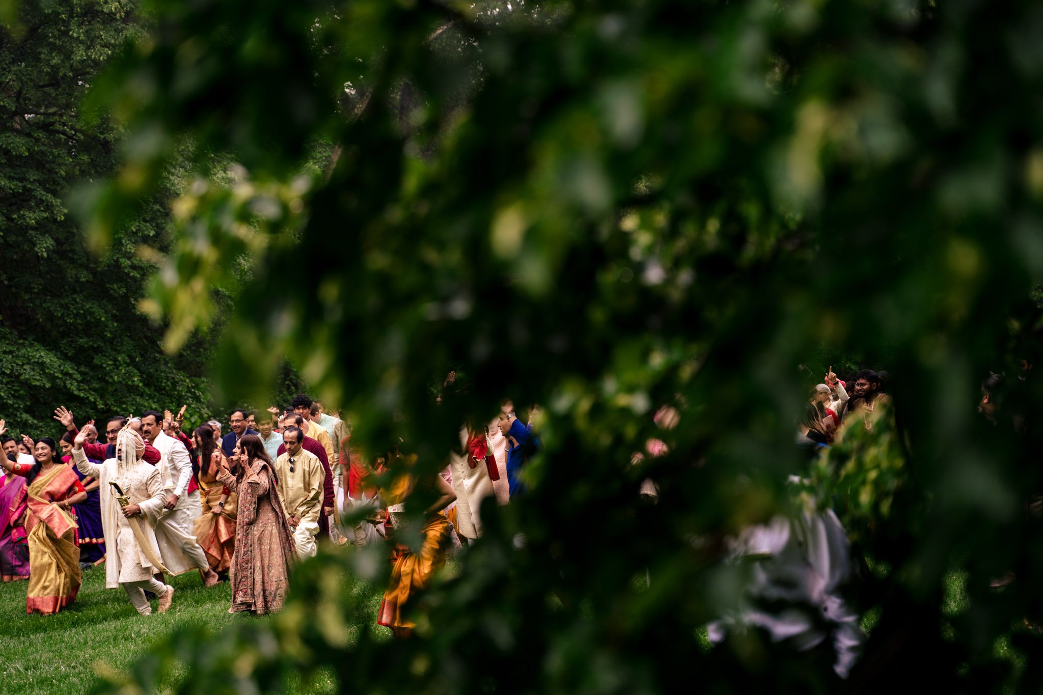 A group of people walking through a grassy area at a Biltmore Estate wedding.