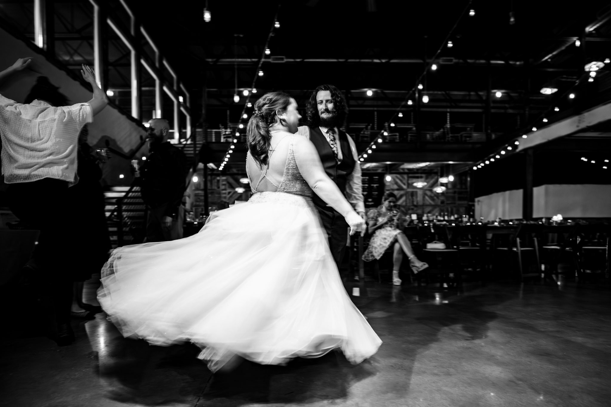 A bride and groom dancing at a highland brewing wedding reception.