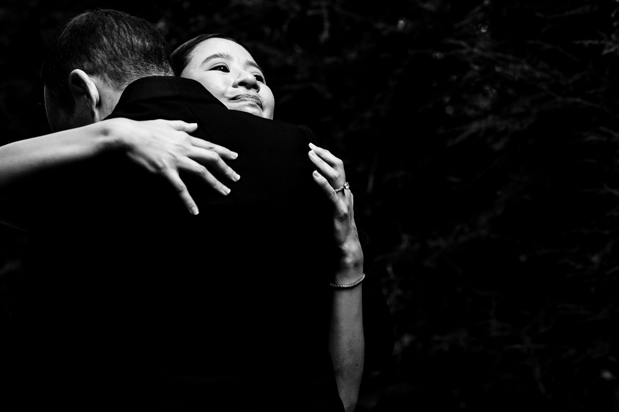 A black and white photo of a couple hugging.