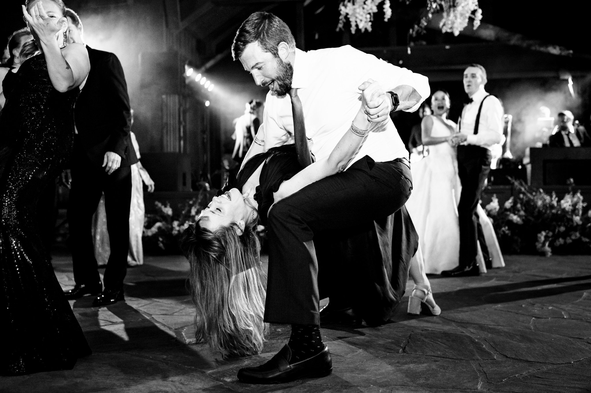 Black and white photo of a couple dancing on the dance floor at an old Edwards wedding.