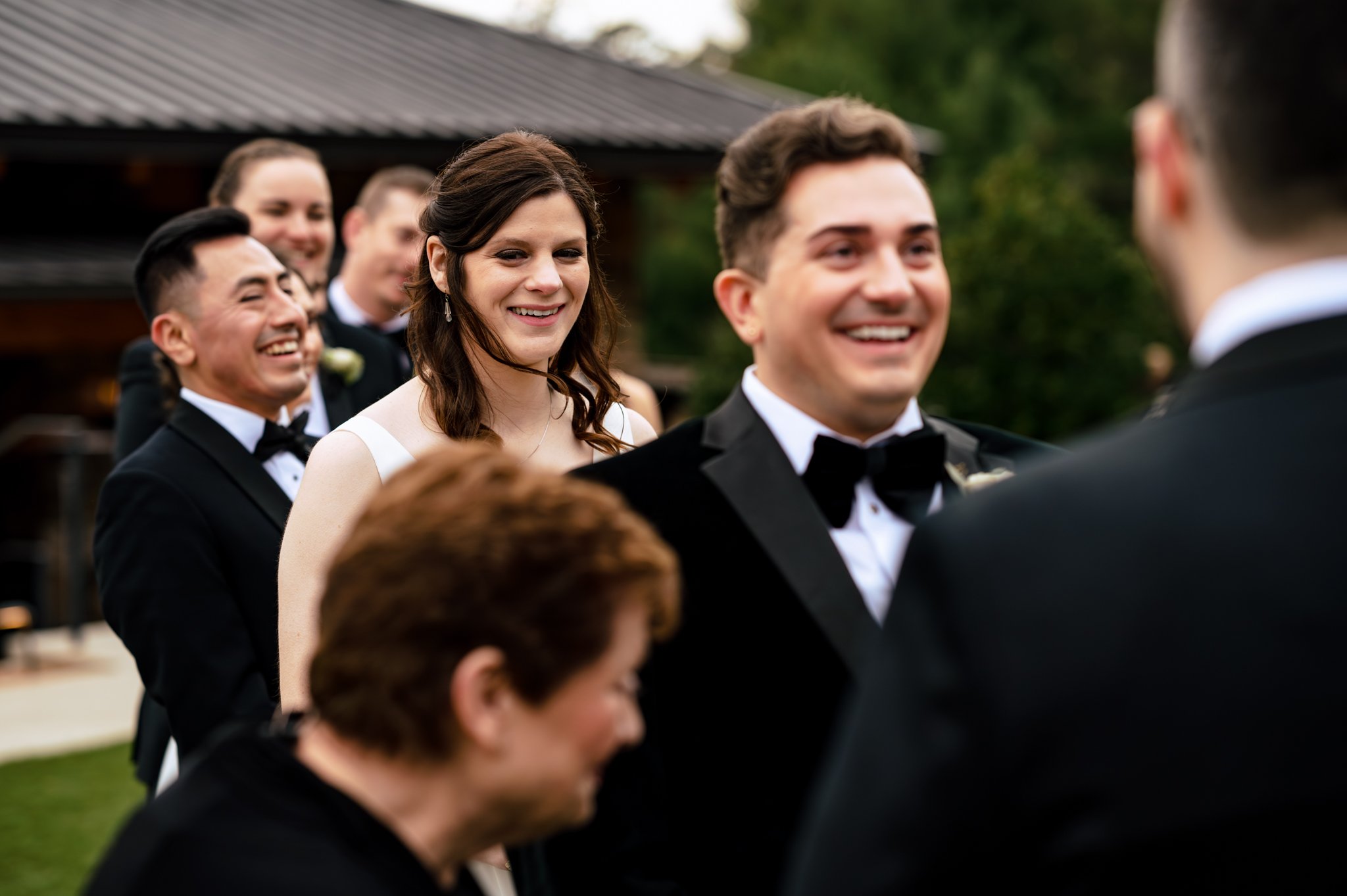 A bride and groom smile at each other as they walk down the Grove Park Inn wedding aisle.