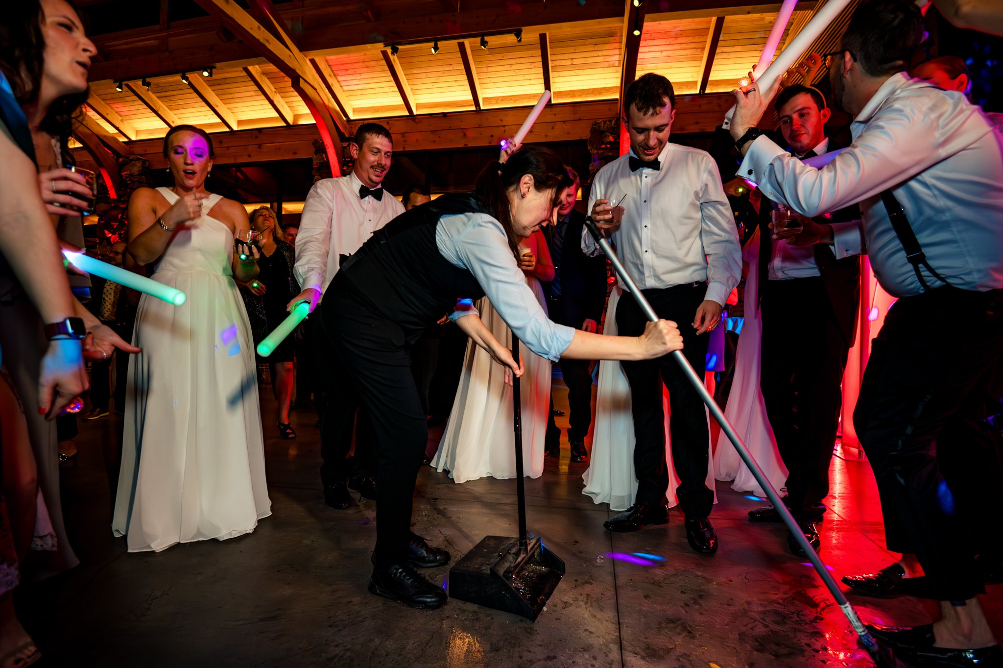 A group of people at a party with lightsabers at Seely Pavilion.