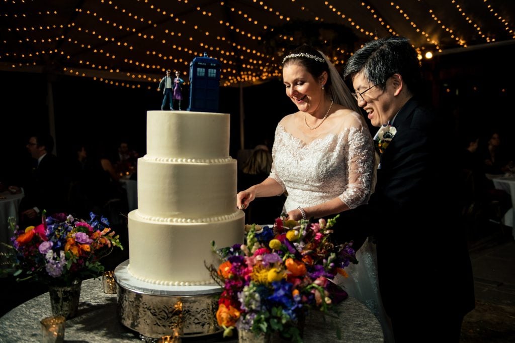 Sarah P. Duke Gardens wedding - A bride and groom cutting a wedding cake.