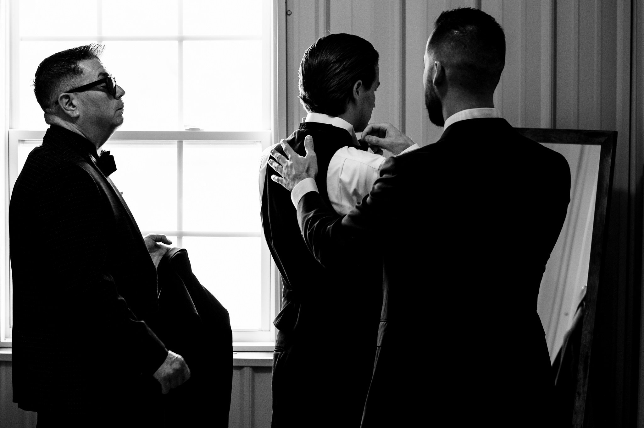 An intimate gathering of men in suits at an Asheville micro wedding.