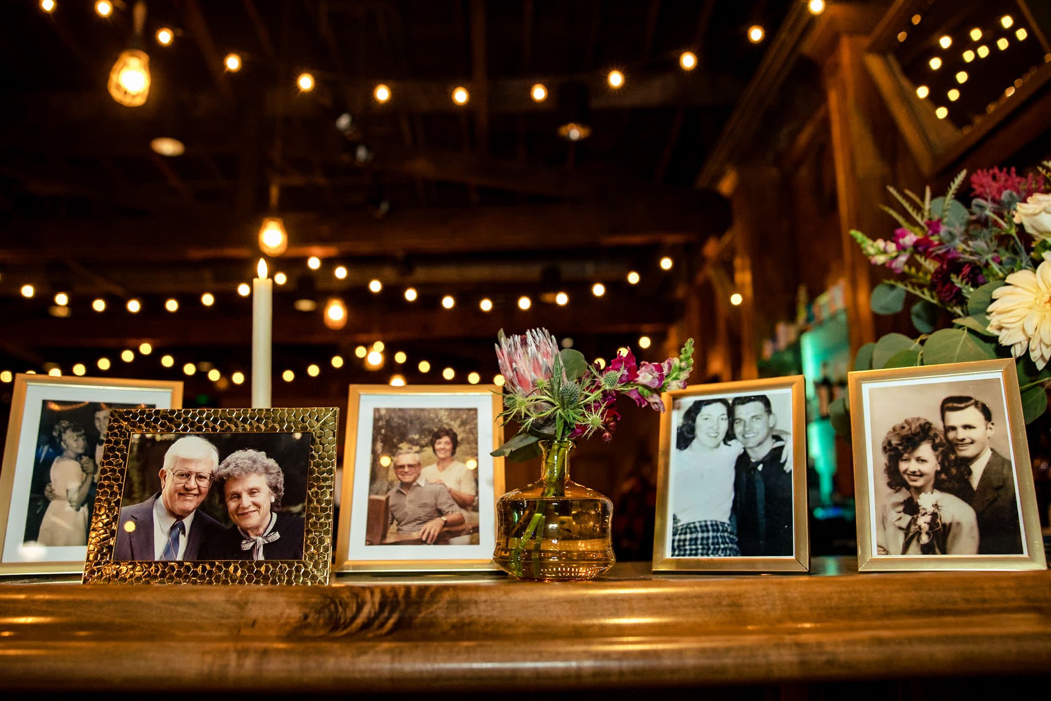 Framed photos on a table at an Asheville wedding reception.