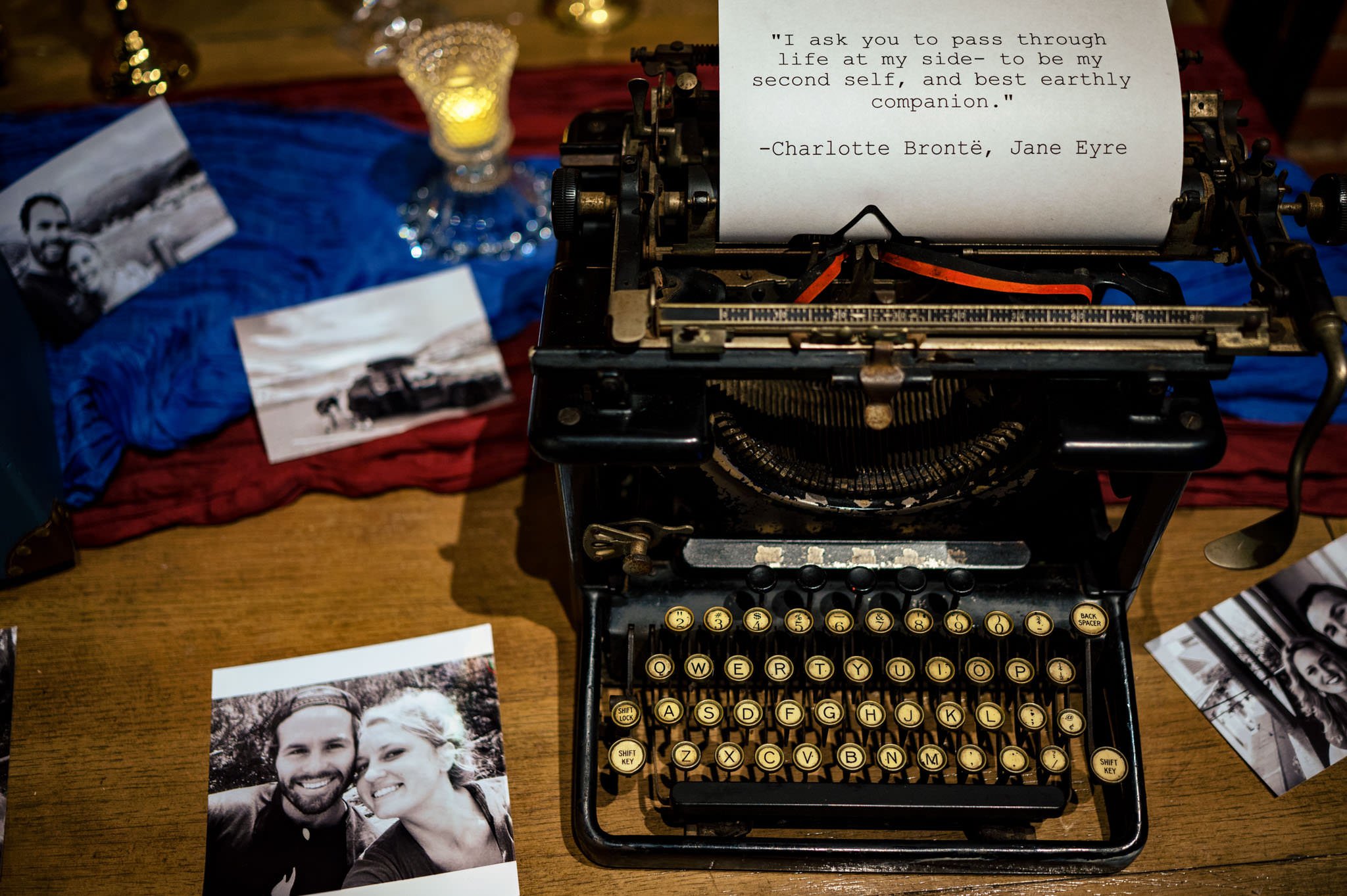 A typewriter sits on a table next to photos at an Asheville wedding.
